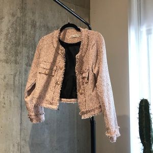Pink jacket with gold buttons and frayed edges